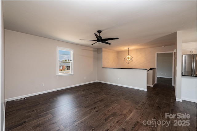 unfurnished room with dark hardwood / wood-style floors and ceiling fan