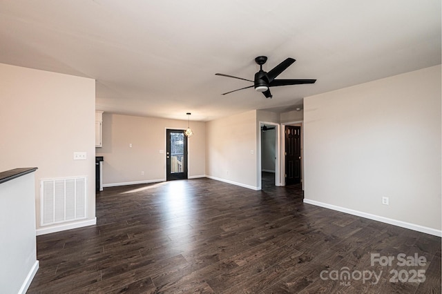 empty room with dark wood-type flooring and ceiling fan