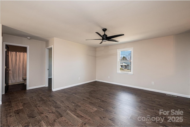 empty room with dark hardwood / wood-style floors and ceiling fan