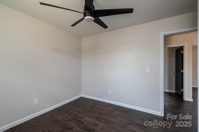 empty room featuring ceiling fan and dark hardwood / wood-style flooring