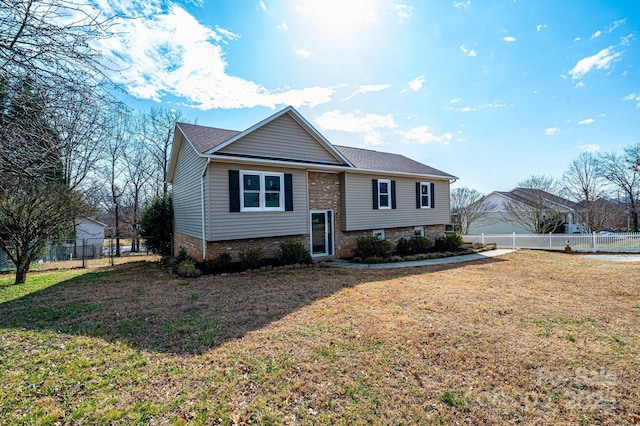 raised ranch with a front lawn