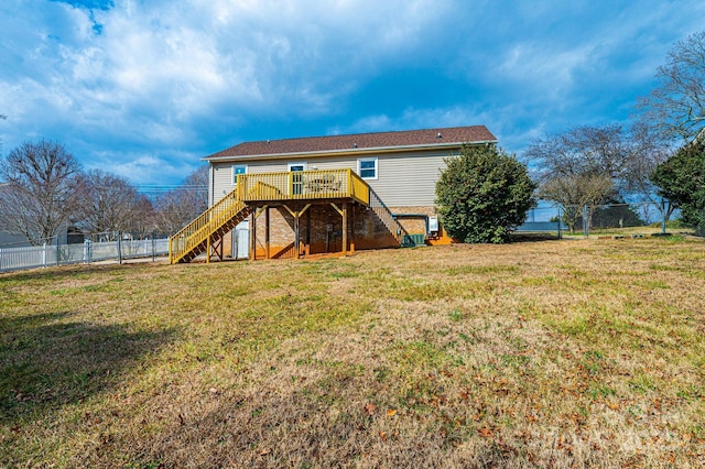 back of property featuring a yard and a deck