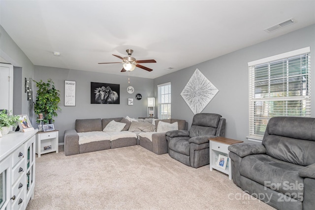 living room featuring ceiling fan, carpet flooring, and visible vents