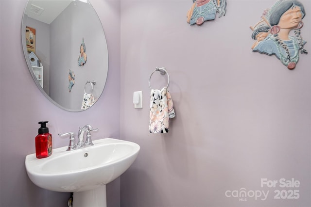 bathroom with a sink and visible vents