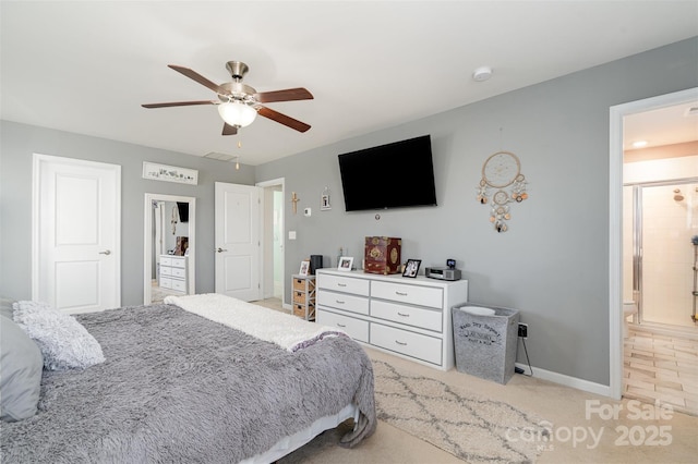 bedroom with a ceiling fan, visible vents, baseboards, and ensuite bathroom