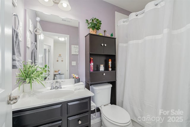 bathroom featuring visible vents, vanity, and toilet