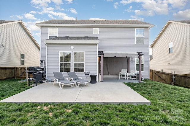 back of property featuring a patio area, a fenced backyard, a pergola, and a lawn