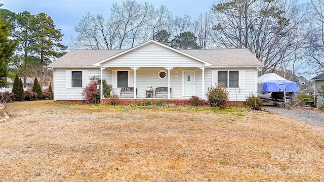 view of front of property with a porch and a front lawn