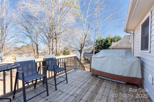 wooden deck with a grill