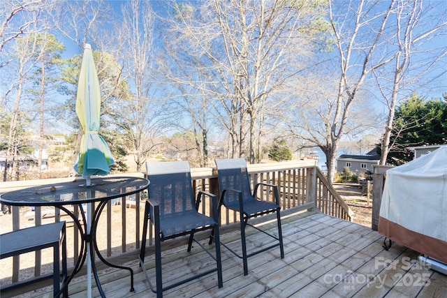 wooden terrace with a grill