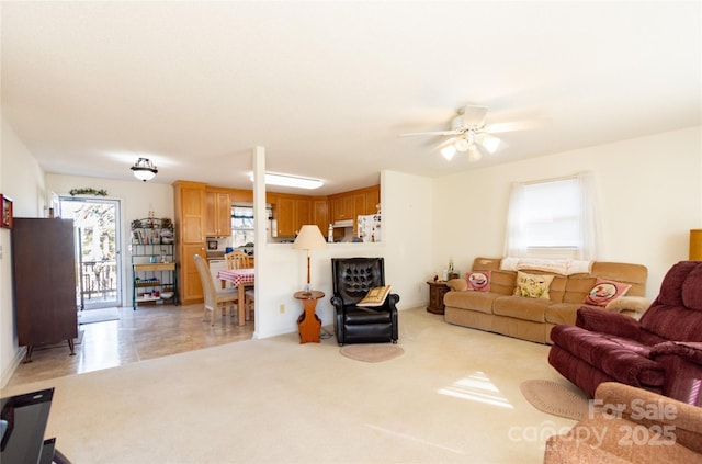 carpeted living room with ceiling fan