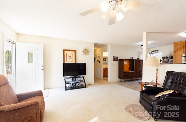 living room with light carpet and ceiling fan