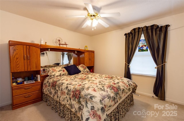 bedroom featuring light colored carpet and ceiling fan