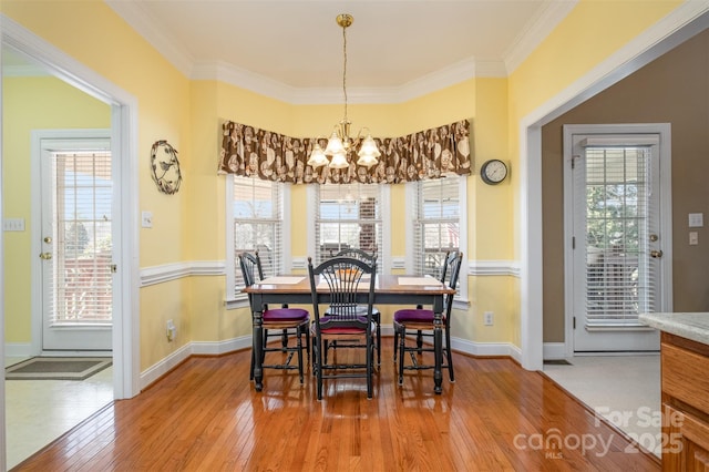 dining space featuring hardwood / wood-style floors and a healthy amount of sunlight