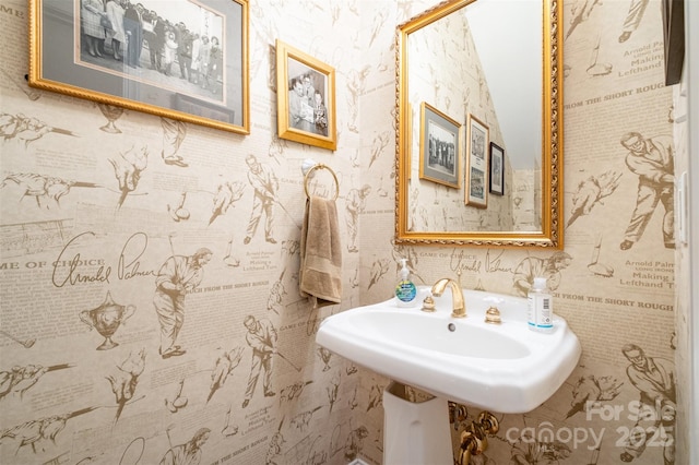 bathroom with wallpapered walls