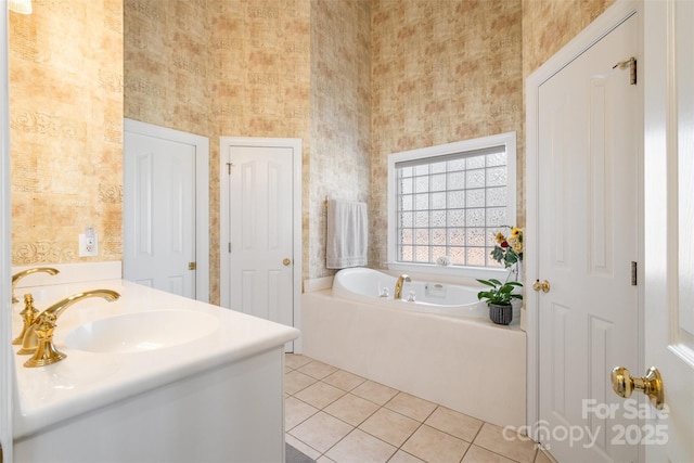 bathroom with tile patterned flooring, double vanity, a sink, and a bath