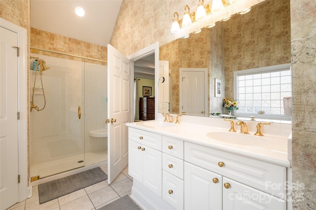 bathroom featuring double vanity, tile patterned floors, a sink, and a shower stall