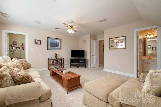 living room with light colored carpet, visible vents, and baseboards