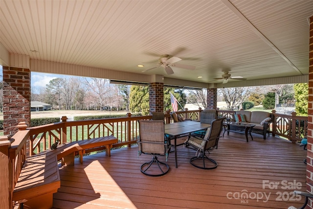 wooden deck with ceiling fan and outdoor dining area