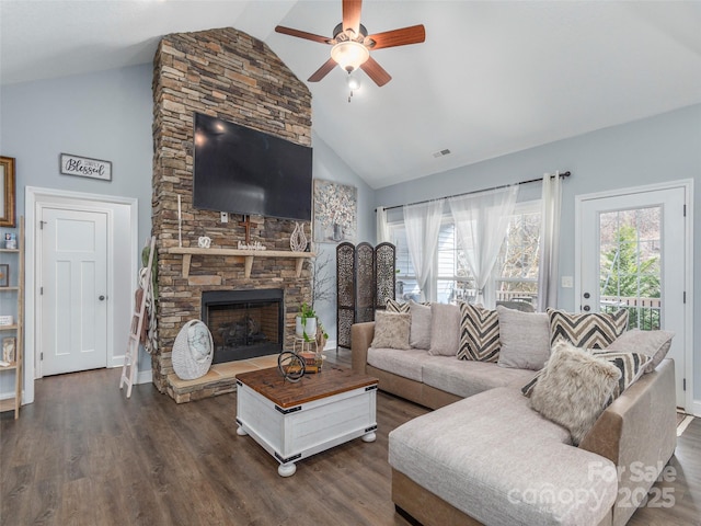 living room featuring dark hardwood / wood-style flooring, a stone fireplace, high vaulted ceiling, and ceiling fan