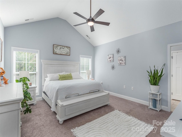 bedroom with ceiling fan, high vaulted ceiling, light carpet, and multiple windows