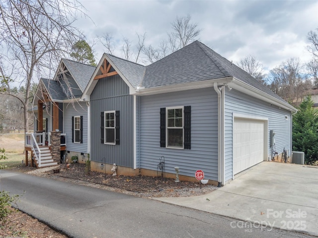 view of side of property featuring cooling unit and a garage