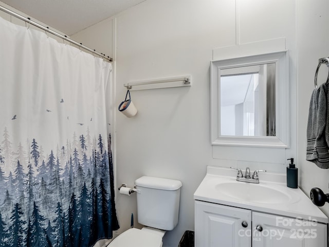 bathroom with vanity, toilet, and a shower with shower curtain