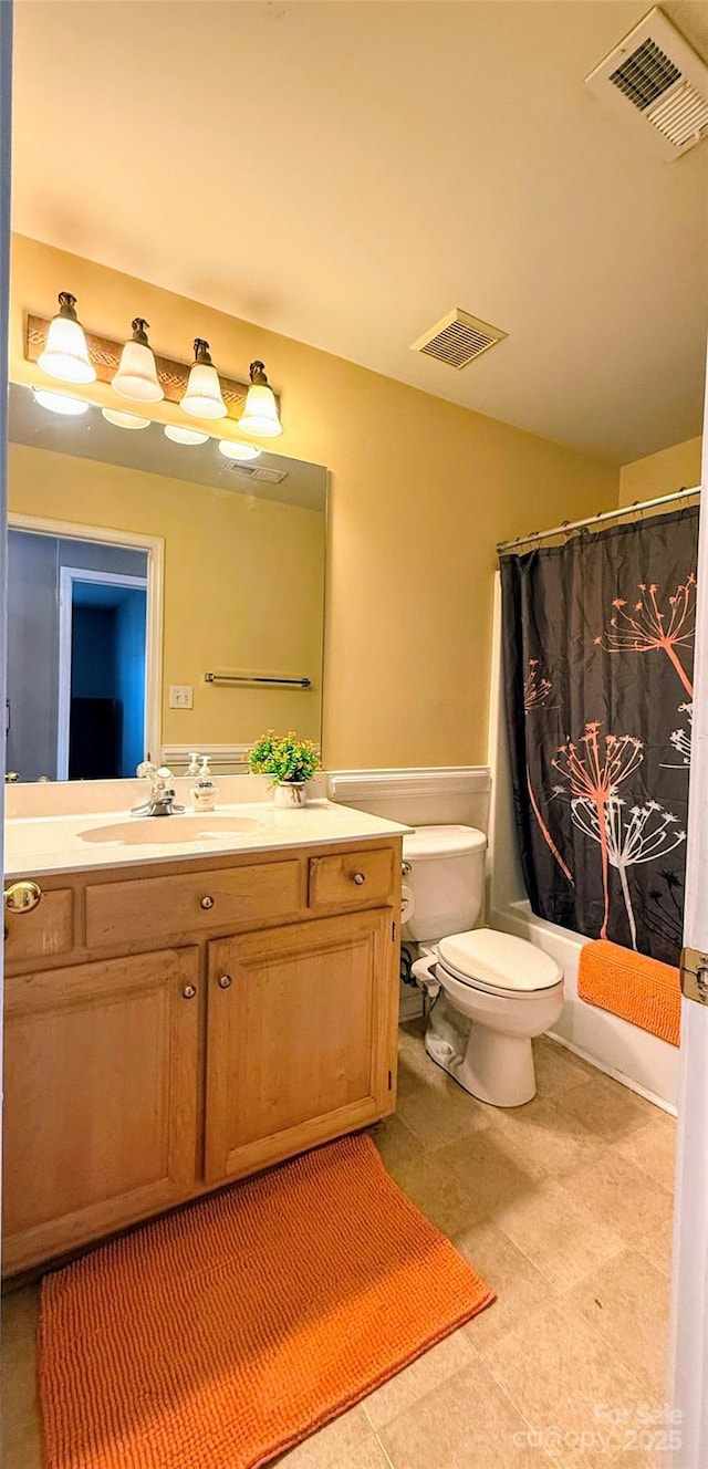 full bathroom with vanity, shower / bath combo, and toilet