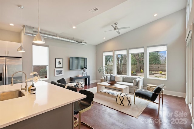 living room with lofted ceiling, sink, and ceiling fan