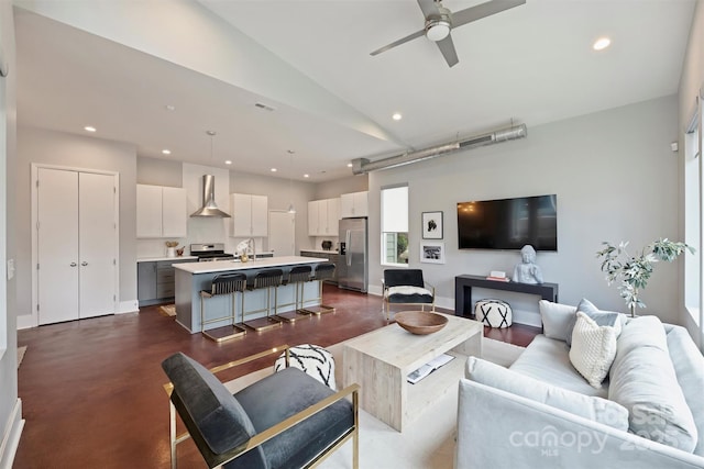 living room with lofted ceiling, sink, and ceiling fan