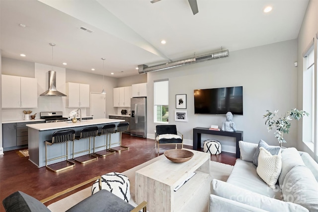 living room featuring sink and ceiling fan