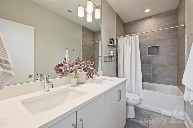 full bathroom featuring tile patterned floors, vanity, toilet, and shower / tub combo