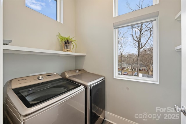 clothes washing area with independent washer and dryer