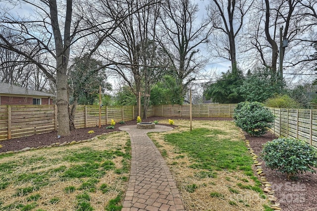 view of yard with an outdoor fire pit