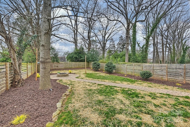 view of yard with a fire pit