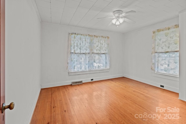 unfurnished room featuring hardwood / wood-style floors, crown molding, and ceiling fan