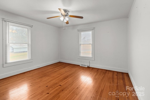 empty room with wood-type flooring and ceiling fan