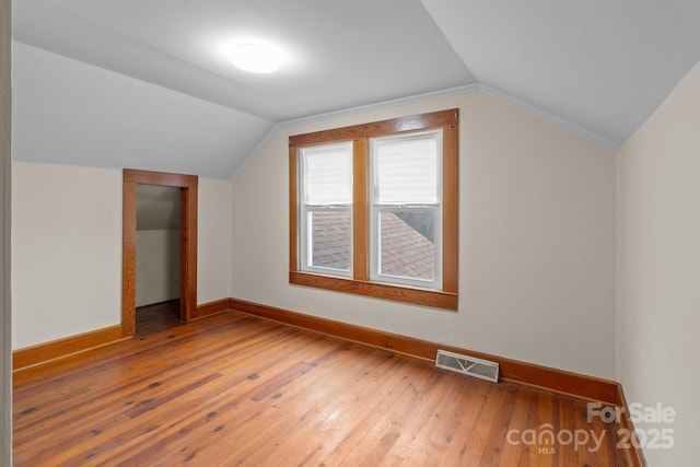 bonus room featuring wood-type flooring and lofted ceiling