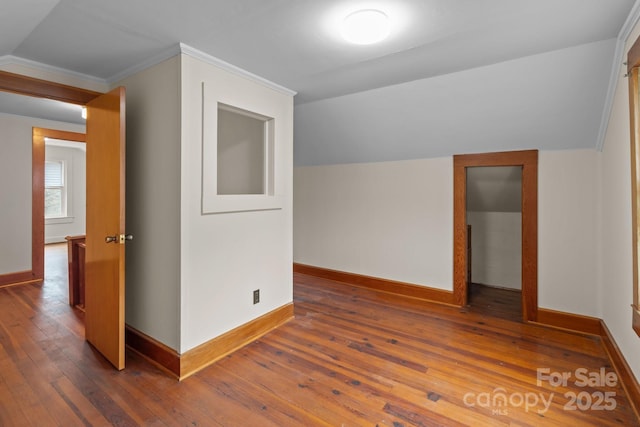 additional living space featuring vaulted ceiling and dark hardwood / wood-style floors