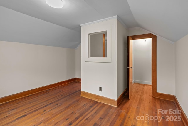 additional living space featuring hardwood / wood-style flooring and vaulted ceiling