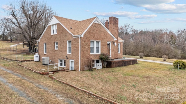 view of property exterior featuring central AC unit and a lawn