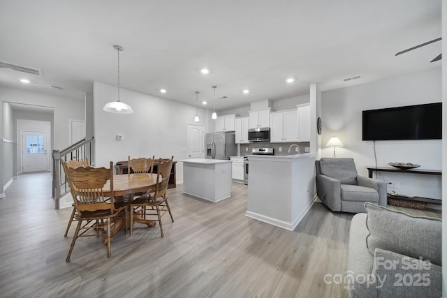 dining space featuring ceiling fan and light hardwood / wood-style flooring