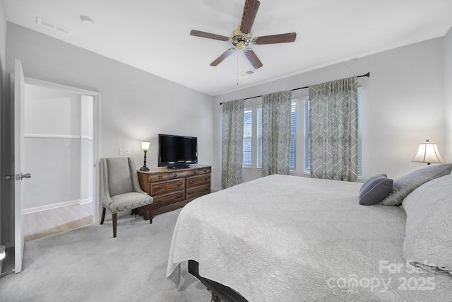 bedroom featuring light carpet and ceiling fan