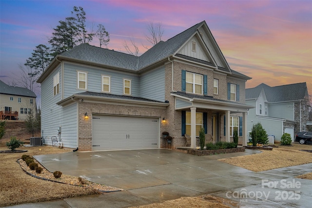 view of front of home featuring cooling unit, a garage, and covered porch