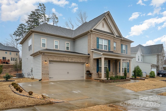 view of front facade featuring cooling unit, a garage, and covered porch