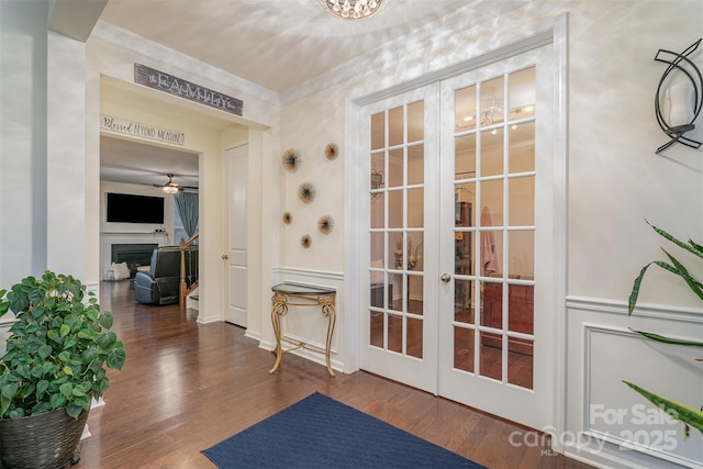 entryway with dark hardwood / wood-style flooring, crown molding, french doors, and ceiling fan