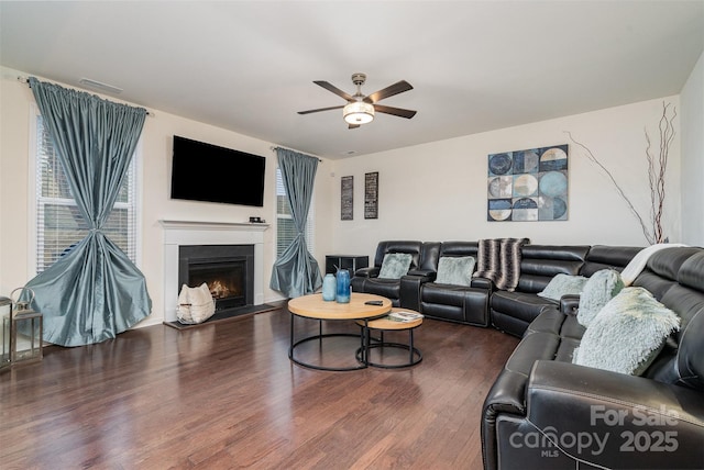 living room with dark wood-type flooring and ceiling fan