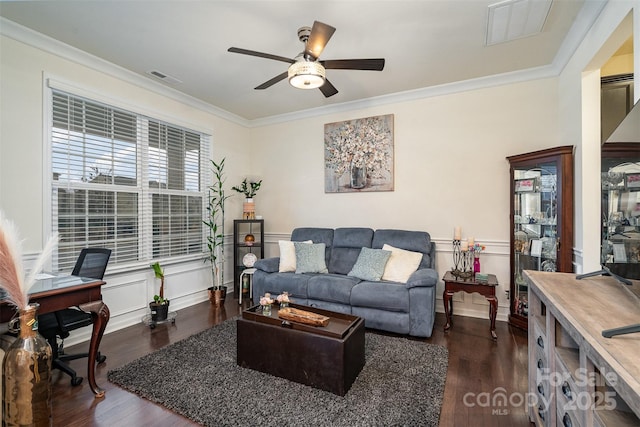 living room with ornamental molding, dark hardwood / wood-style floors, and ceiling fan
