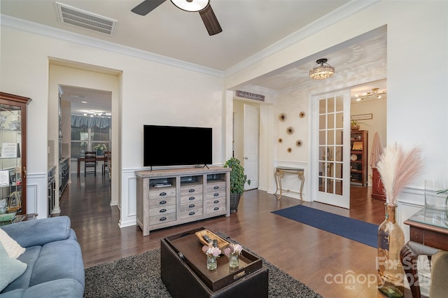 living room with ornamental molding, dark hardwood / wood-style floors, and ceiling fan