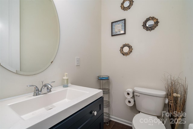 bathroom featuring hardwood / wood-style flooring, vanity, and toilet